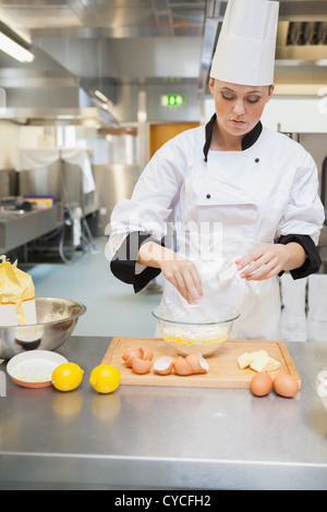 Female baker making dough Stock Photo