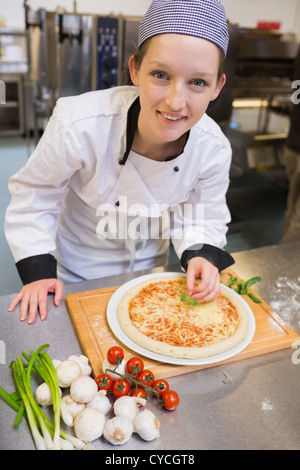 Smiling chef preparing pizza Stock Photo