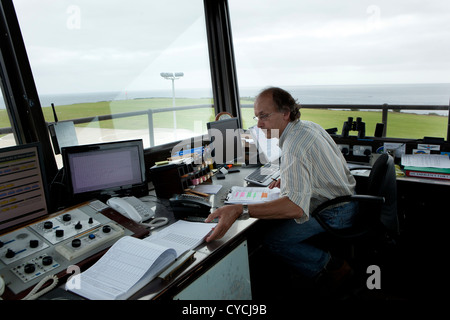 An air traffic controller in the tower at Isles of Scilly Airport, St Mary's, Scilly Stock Photo