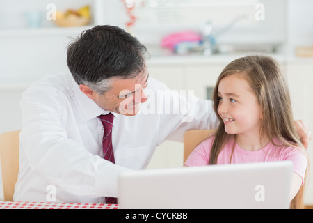 Father and daughter using laptop Stock Photo
