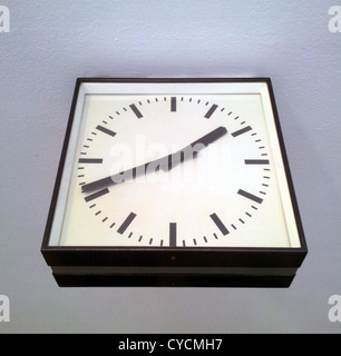 Square station clock hanging on wall Stock Photo