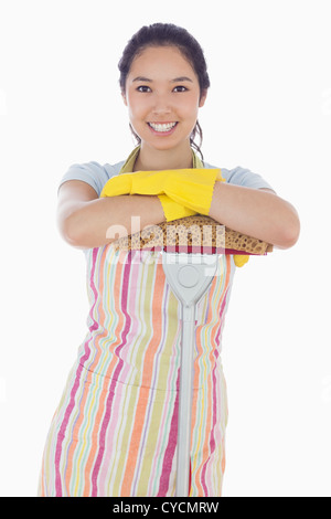 Smiling woman leaning on mop Stock Photo