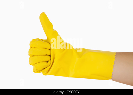 Female hand in yellow glove giving the thumbs up