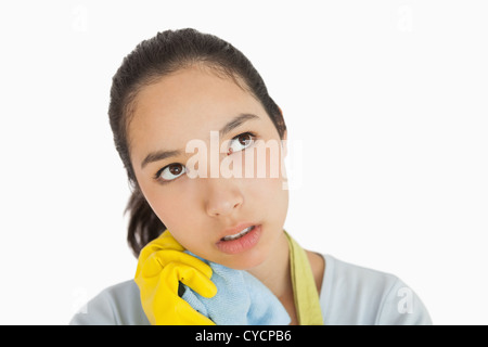 Tired woman clutching cleaning rag Stock Photo - Alamy