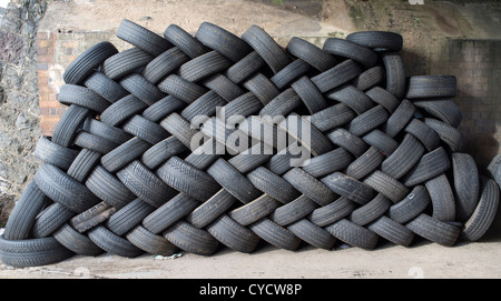 October 31st 2012. Exeter, Devon, England.  Tyres tires stacked up in a geometric way at a tyre tire depot. Stock Photo