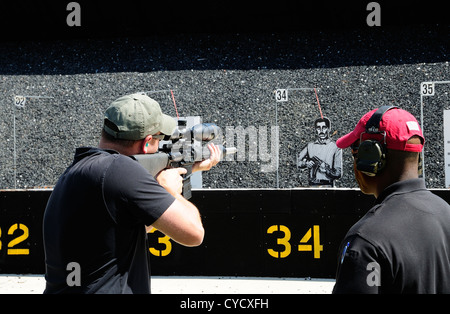 Gunman test firing automatic rifle at the FBI shooting range in Chicago, Illinois, USA. Identity concealed by request. Stock Photo