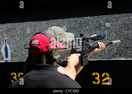 Gunman test firing automatic rifle at the FBI shooting range in Chicago, Illinois, USA. Identity concealed by request. Stock Photo