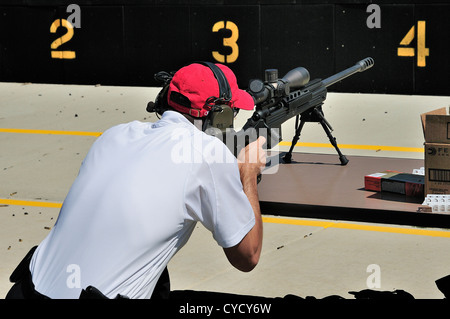 Gunman test firing .338 sniper rifle at the FBI shooting range in Chicago, Illinois, USA. Identity concealed by request. Stock Photo