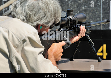 Gunman test firing .338 sniper rifle at the FBI shooting range in Chicago, Illinois, USA. Identity concealed by request. Stock Photo