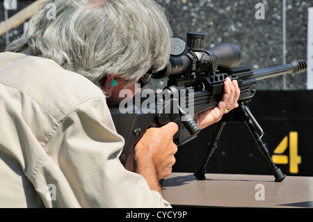 Gunman test firing .338 sniper rifle at the FBI shooting range in Chicago, Illinois, USA. Identity concealed by request. Stock Photo