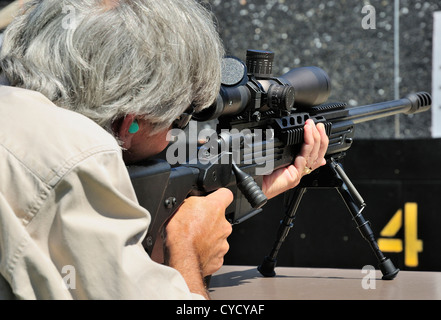 Gunman test firing .338 sniper rifle at the FBI shooting range in Chicago, Illinois, USA. Identity concealed by request. Stock Photo