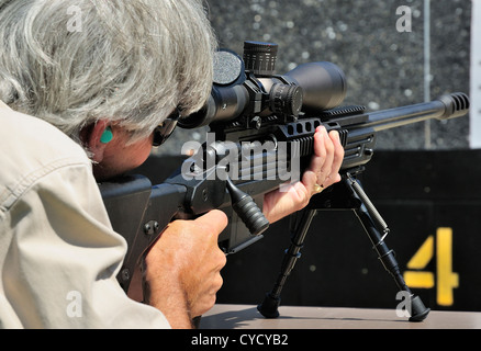 Gunman test firing .338 sniper rifle at the FBI shooting range in Chicago, Illinois, USA. Identity concealed by request. Stock Photo