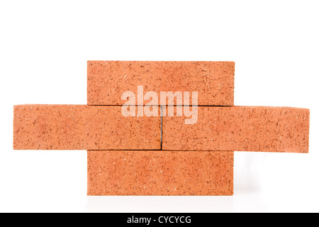 Four clay bricks building a wall Stock Photo