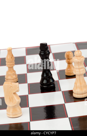 White pieces surrounding the black queen Stock Photo