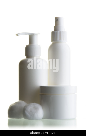 White, plastic, cosmetic containers and balls of cotton against white background with table reflection Stock Photo