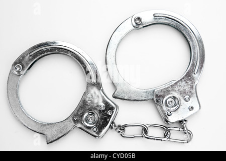 Handcuffs against white background Stock Photo
