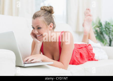 Joyful blonde using notebook Stock Photo
