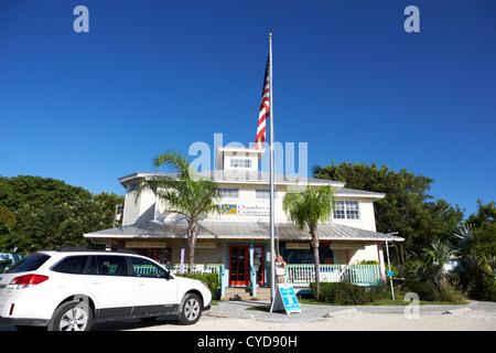 raising the american flag on a flagpole outside the chamber of commerce building in key largo florida keys usa Stock Photo