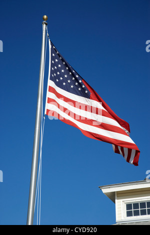 american flag on a flagpole outside the chamber of commerce building in key largo florida keys usa