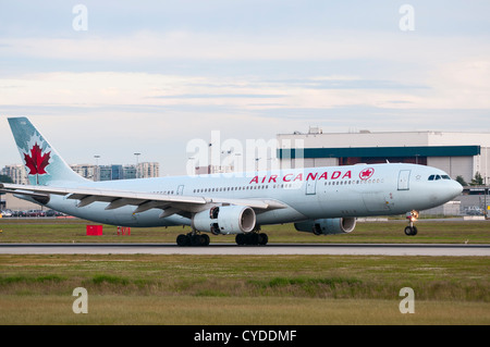 An Air Canada Airbus A330-300 jetliner deploys its engine thrust reversers as it lands at Vancouver International Airport. Stock Photo