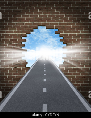 Break through to opportunity concept with a highway going through a broken brick wall to a shinning light of success on a sky background as a business icon and a symbol for a new life vision, Stock Photo