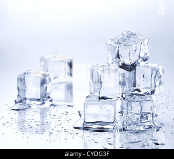 Melting ice cubes on glass table Stock Photo