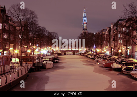 Snowy Amsterdam at night with the Westerkerk in the Netherlands Stock Photo