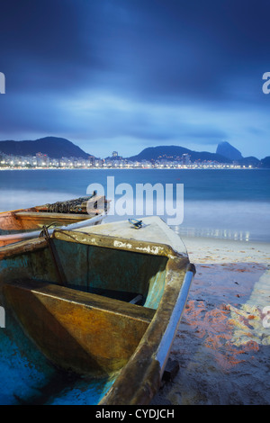 Fishing boats on Copacabana beach at dusk, Rio de Janeiro, Brazil Stock Photo