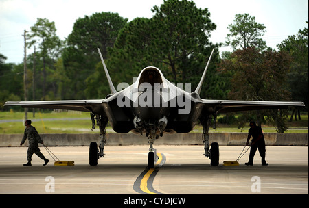 US Air Force crew pull the wheel chalks on the F-35A Lightning II joint strike fighter September 18, 2012 at Eglin Air Force Base, Florida before taking off for a local training mission over the Emerald Coast. Stock Photo