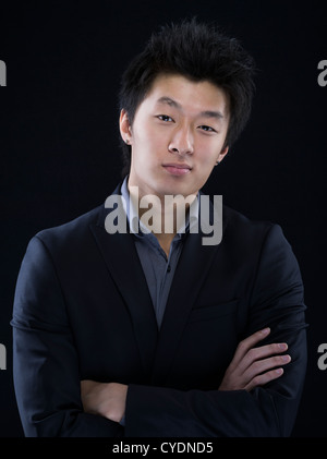 Young asian male in suit and grey shirt Stock Photo