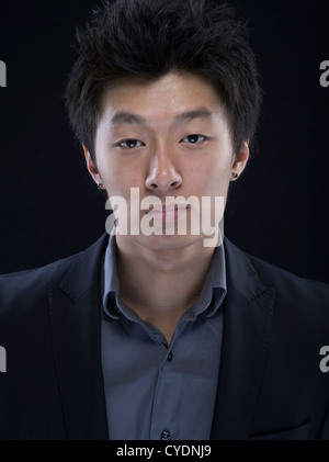 Young asian male in suit and grey shirt Stock Photo