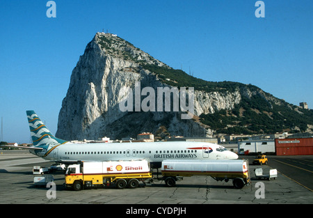 A BRITISH AIRWAYS AIRCRAFT  IS REFUELED ON THE TARMAC AT GIBRALTAR AIRPORT AGAINST BACKGROUND OF THE ROCK' Stock Photo