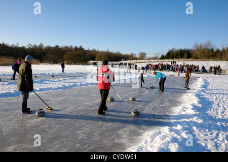 Curling on frozen Bush Loch, Gatehouse of Fleet, Dumfries & Galloway, Scotland Stock Photo