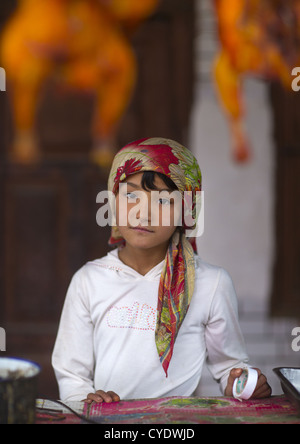 Young Uyghur Girl At Food Stall, Keriya, Old Town, Xinjiang Uyghur Autonomous Region, China Stock Photo