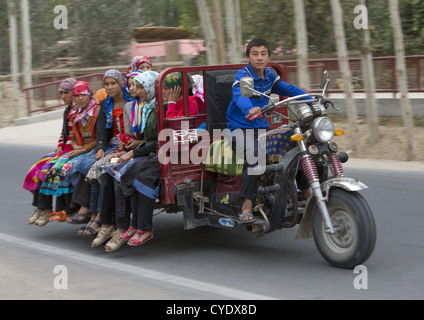Uyghur Teenager Driving Girls In A Cart, Hotan, Xinjiang Uyghur Autonomous Region, China Stock Photo