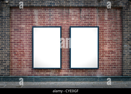 Two blank billboards attached to a buildings exterior brick wall. Stock Photo