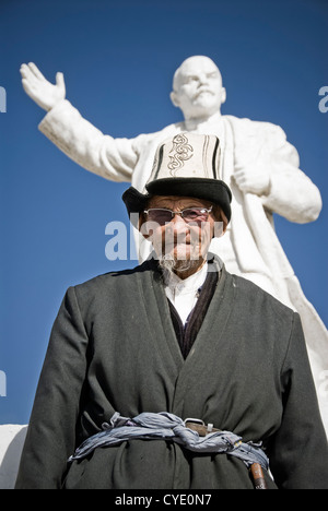 Local Kyrgyz man in front of the statue of Lenin, Murgab, Tajikistan. Stock Photo