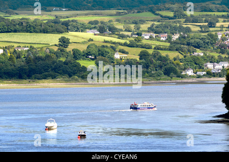 Sightseeing cruise boat heads up the Conwy valley after leaving Conwy quayside hilly countryside landscape beyond Clwyd North Wales UK Stock Photo