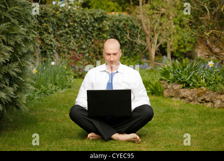 Successful businessman in white shirt and tie working and relaxing outdoors Stock Photo