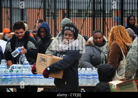 Nov. 2, 2012 - Manhattan, New York, U.S. - Members of the Air National Guard Unit 105th out of Stewart Air Force Base with community volunteers deliver and distribute food, water, toiletries, cleaning supplies and other goods to residents in the East Village at a distribution center at Vladic Palyground on East 10th Street between Avenue C and Avenue D near the ConEd plant on East 14th Street this afternoon following the effects of Hurricane Sandy in New York, November 2, 2012. (Credit Image: © Bryan Smith/ZUMAPRESS.com) Stock Photo