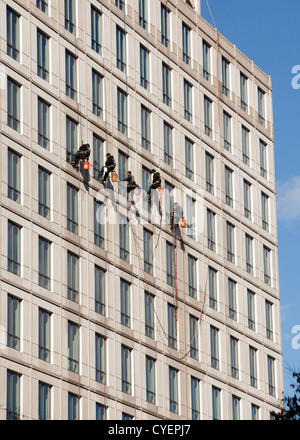 Window cleaners on a highrise building Stock Photo