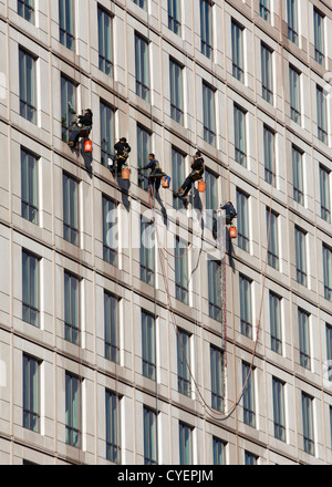 Window cleaners on a highrise building Stock Photo