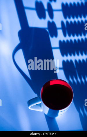 Mug in the shadows on the background of wood accounts Stock Photo