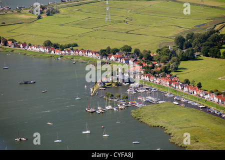 The Netherlands, Durgerdam, Amsterdam, Houses on dyke of lake called IJmeer. Aerial. Stock Photo