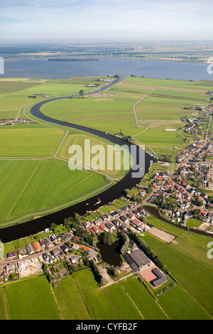 The Netherlands, Bunschoten-Spakenburg, Farms and farmland in Eem polder. Eempolder, and river Eem. Background hamlet of Eemdijk. Aerial. Stock Photo