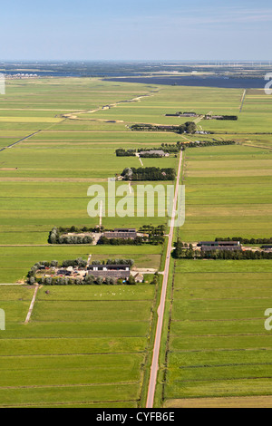 The Netherlands, Bunschoten-Spakenburg, Farms and farmland in Eem polder, Eempolder, and river Eem. Background hamlet of Eemdijk. Aerial. Stock Photo