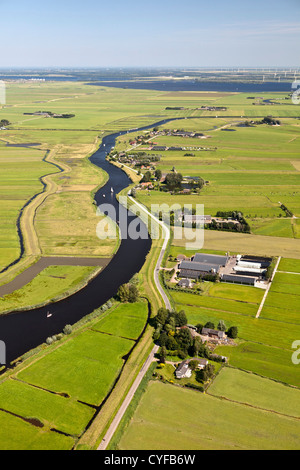 The Netherlands, Bunschoten-Spakenburg, Farms and farmland in Eem polder. Eempolder, and river Eem. Background hamlet of Eemdijk. Aerial. Stock Photo