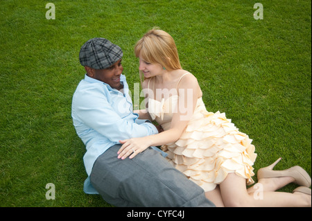 Paris, France - Couple in love lying on grass Stock Photo