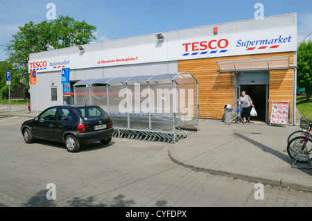 Woman with trolley leaving Tesco supermarket in Wadowice, Poland. Stock Photo