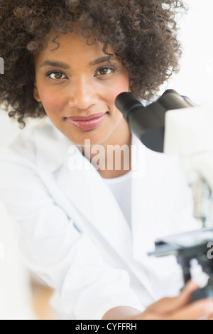 USA, New Jersey, Jersey City, Woman using microscope in laboratory Stock Photo